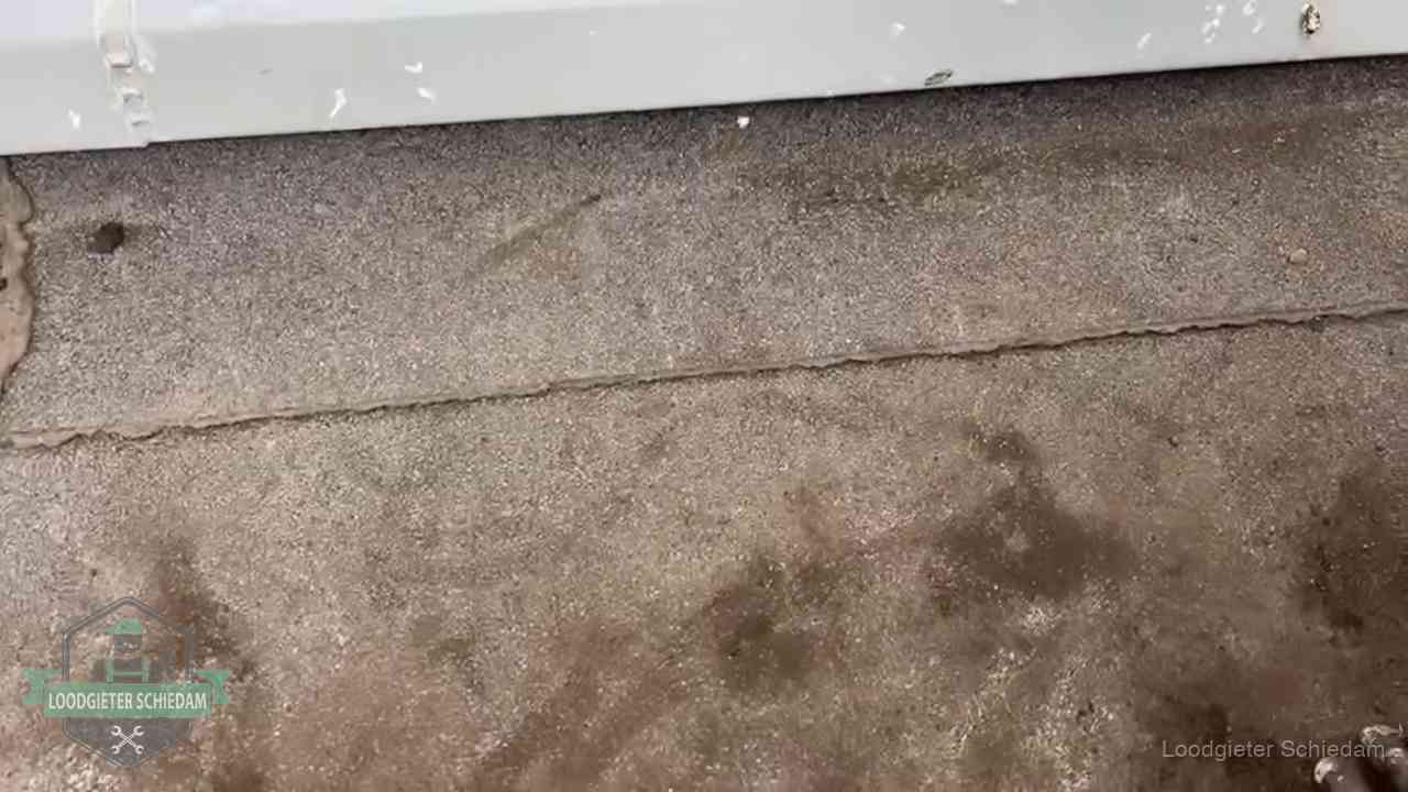 Stormschade en neerslag op daken in Schiedam Vochtplekken bij de naad van een plat dak na aanhoudende regen in Schiedam